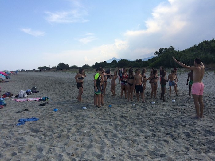 Groupe d'ado faisant un jeu sur la plage lors d'une colonie de vacances corse