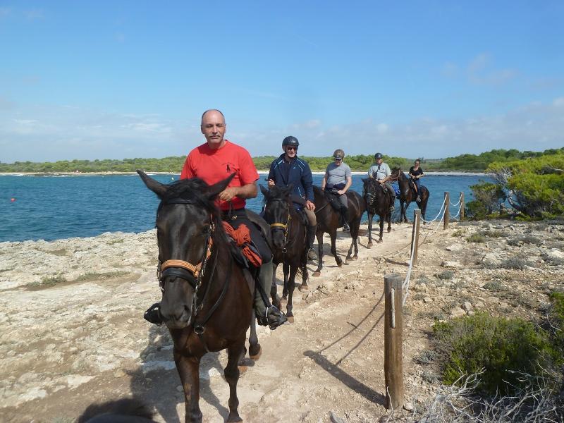 Un moniteur et un groupe de cavalier pendant une colonie de vacances équitation