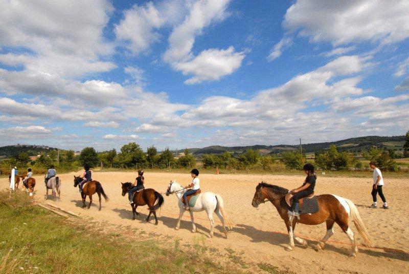 Les enfants de la colonie de vacances Tarn-et-Garonne font la queue-leu leu à dos de cheval