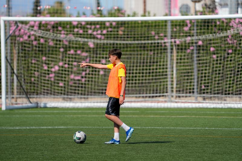 garçon seul avec son ballon sur un terrain de foot lors d'un stage de langue espagnol