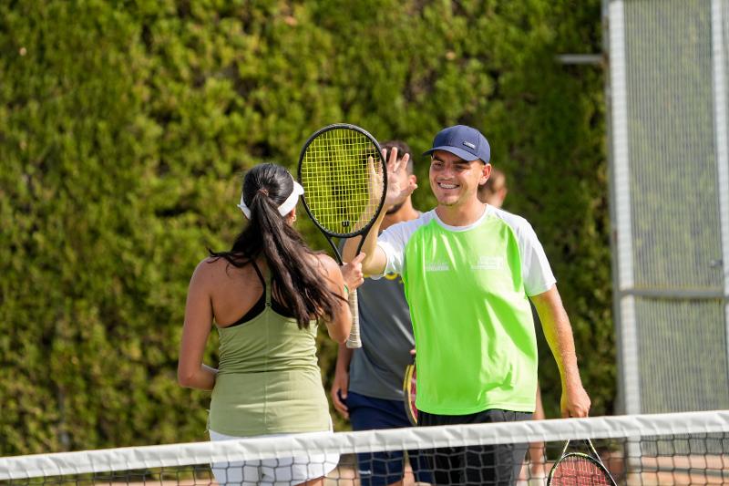 deux jeunes qui font un check après un match de tennis lors d'un stage de langue espagnol