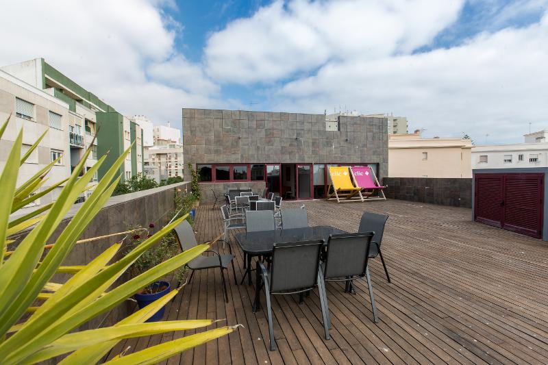 Rooftop de l'école du séjour linguistique espagne avec des tables, chaises et chaises longues XXL