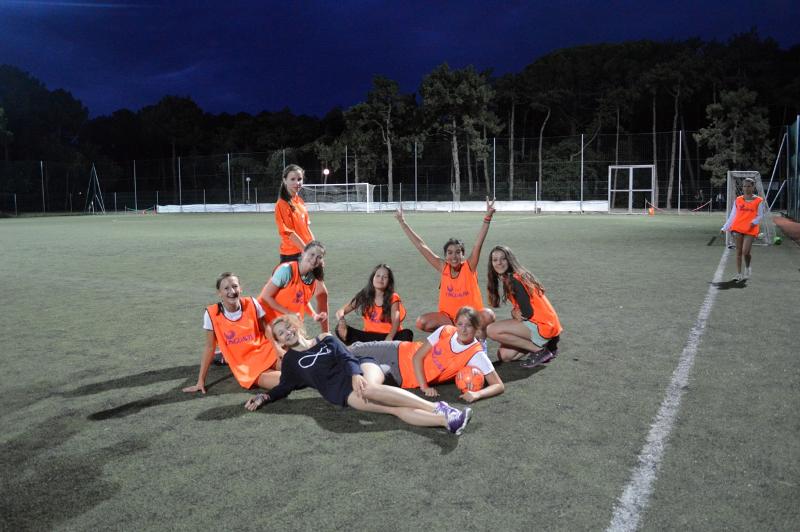 un groupe de jeunes sur un terrain de football la nuit pendant leur séjour linguistique italien