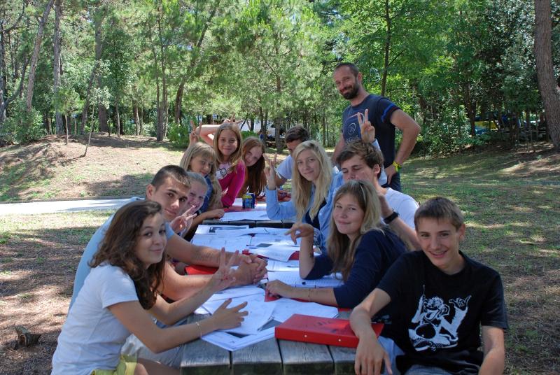 Jeunes autour d'une table de pique-nique pour un cours de langue en pleine nature pendant leur voyage linguistique Italie