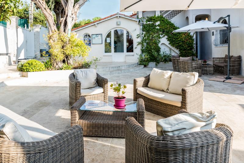 Salon de jardin avec fauteuils, canapé et table basse en rotin lors du séjour linguistique